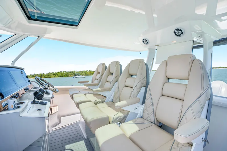 My Honey Yacht Photos Pics Luxurious seating on 2023 Regal 38 SAV boat with modern helm and panoramic views.