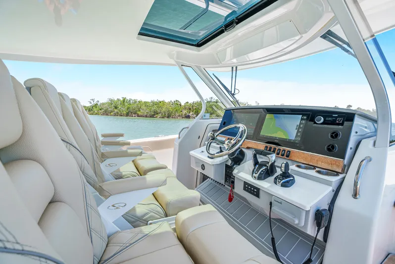 My Honey Yacht Photos Pics 2023 Regal 38 SAV boat interior with modern helm and luxurious seating.