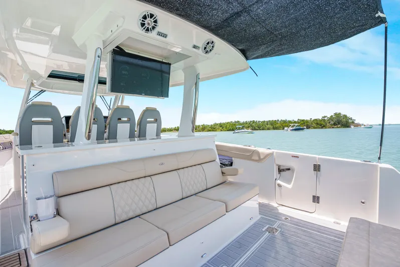 My Honey Yacht Photos Pics 2023 Regal 38 SAV luxury boat interior with seating and ocean view.