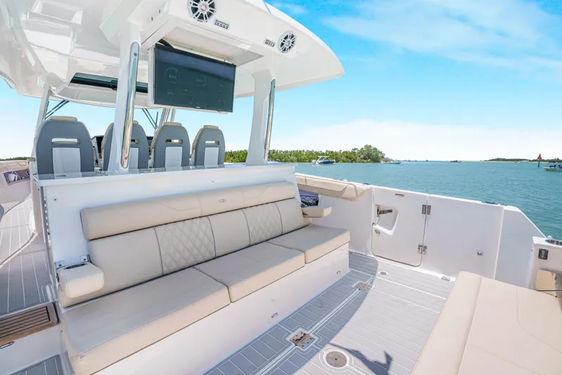 My Honey Yacht Photos Pics 2023 Regal 38 SAV boat interior with seating, ocean view, and modern design.