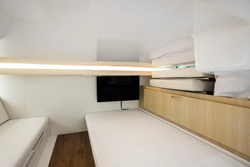My Honey Yacht Photos Pics Interior cabin of 2023 Regal 38 SAV yacht with modern furnishings and TV.