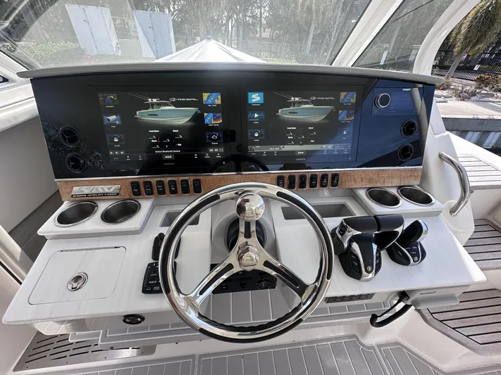 My Honey Yacht Photos Pics 2023 Regal 38 SAV helm with dual displays and modern controls.