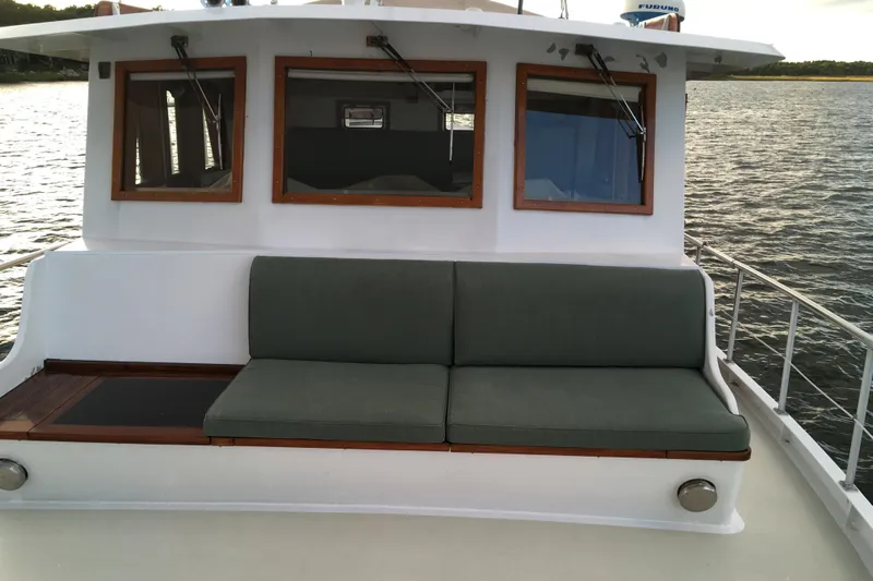  Yacht Photos Pics Custom Jack Gilbert 50 Trawler 1999 with cushioned seating on deck, overlooking calm waters.