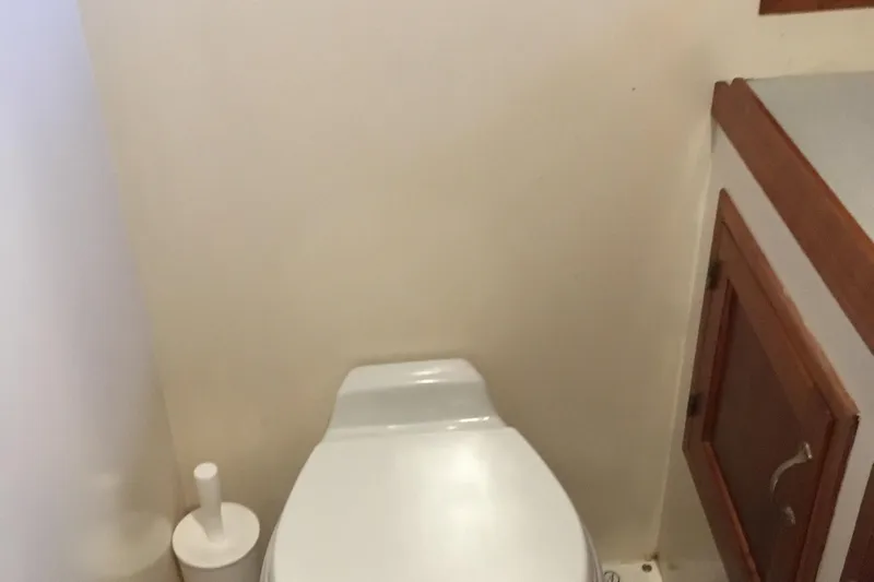  Yacht Photos Pics Bathroom interior of 1999 Custom Jack Gilbert 50 Trawler with toilet and wooden cabinet.