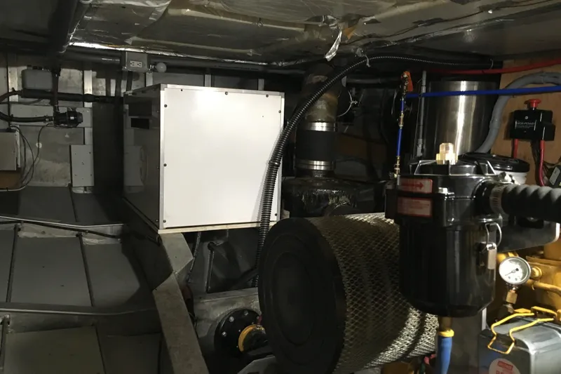  Yacht Photos Pics Engine room of 1999 Custom Jack Gilbert 50 Trawler, showcasing mechanical components and equipment.