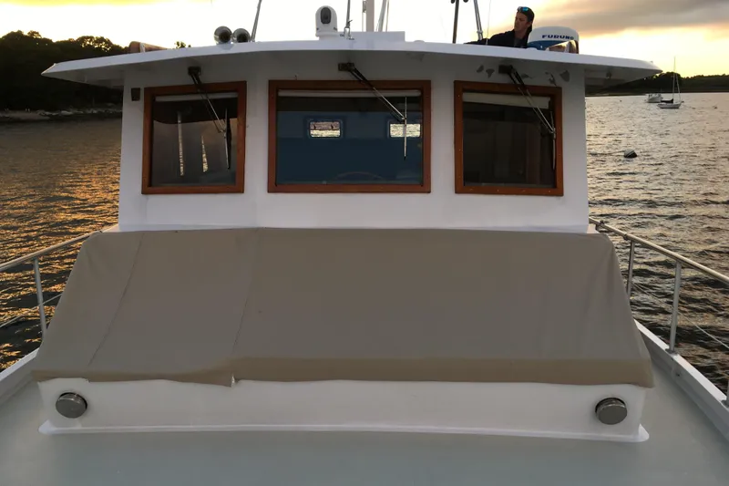  Yacht Photos Pics Custom Jack Gilbert 50 Trawler, 1999 model, docked at sunset with covered deck.