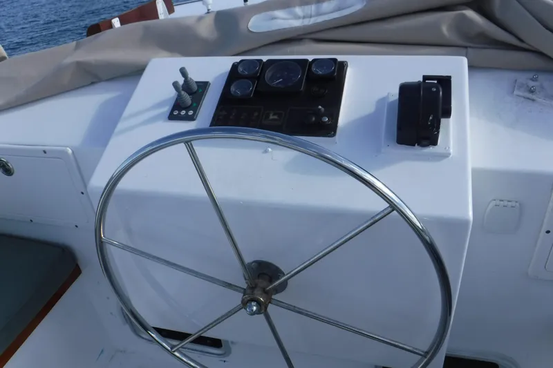  Yacht Photos Pics Helm of 1999 Custom Jack Gilbert 50 Trawler with steering wheel and controls.