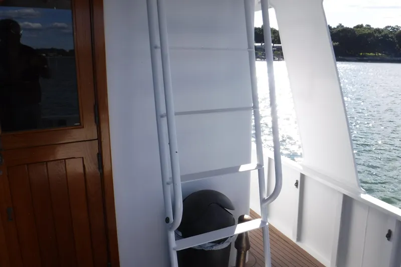  Yacht Photos Pics Wooden door and ladder on 1999 Custom Jack Gilbert 50 Trawler deck, overlooking water.