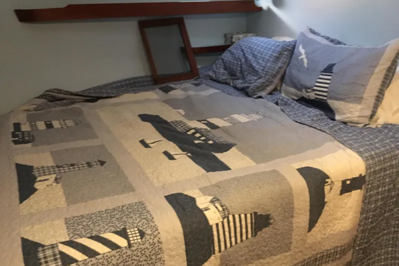  Yacht Photos Pics Cozy bed with lighthouse-themed quilt in 1999 John Gilbert 50 Trawler cabin.