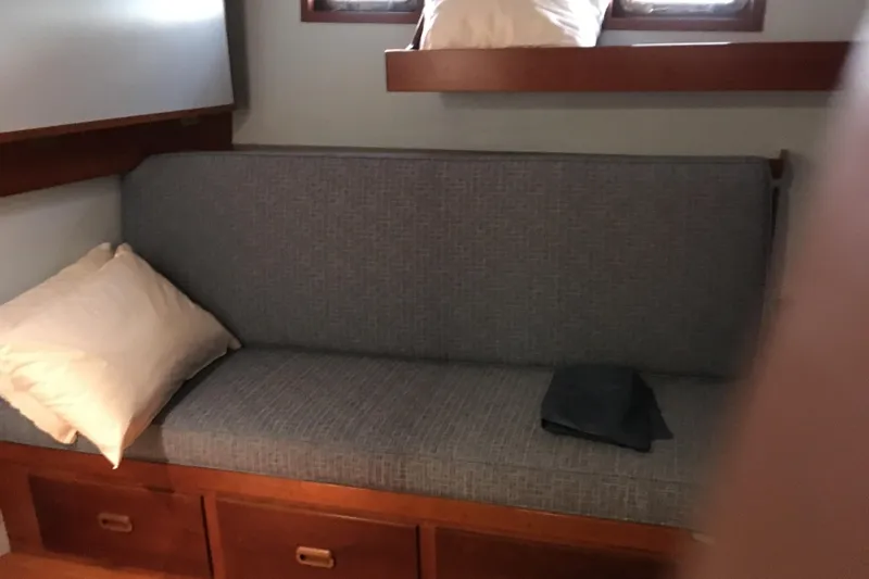  Yacht Photos Pics Interior of 1999 Custom John Gilbert 50 Trawler with cushioned seating and pillows.