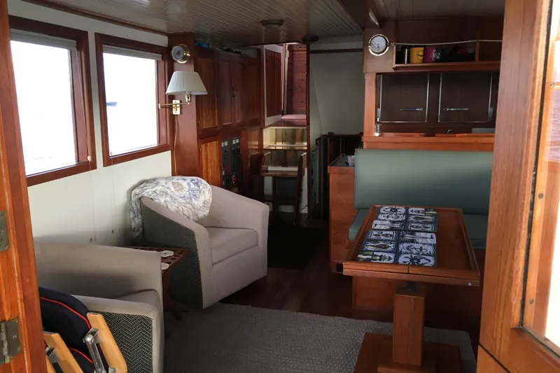  Yacht Photos Pics Cozy interior of 1999 Custom John Gilbert 50 Trawler with wooden furnishings and seating area.