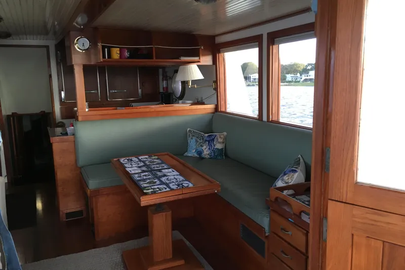  Yacht Photos Pics Cozy interior of 1999 Custom John Gilbert 50 Trawler with wooden furnishings and scenic window views.