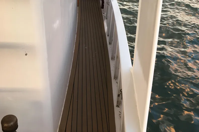  Yacht Photos Pics Side deck of 1999 Custom John Gilbert 50 Trawler with wooden flooring, near water.