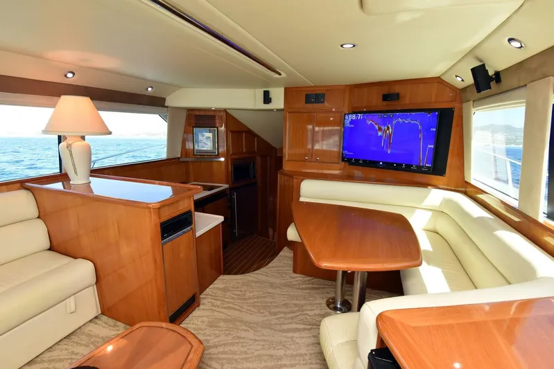 Viviendo El Sueño Yacht Photos Pics Luxurious interior of a 2005 Riviera 51 yacht with wood finishes and modern amenities.
