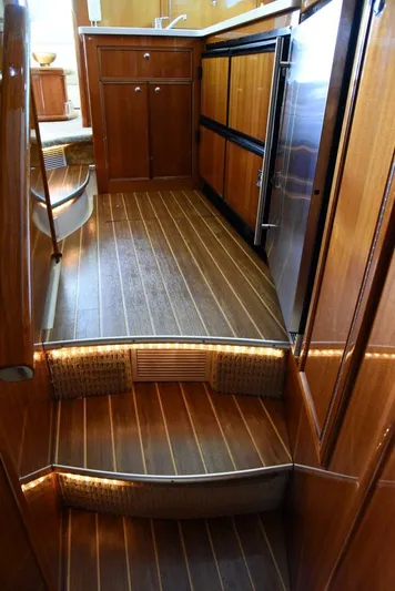 Viviendo El Sueño Yacht Photos Pics 2005 Riviera 51 yacht interior with wooden flooring and cabinetry.