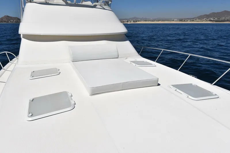 Viviendo El Sueño Yacht Photos Pics 2005 Riviera 51 yacht deck with sunbathing area on open sea.