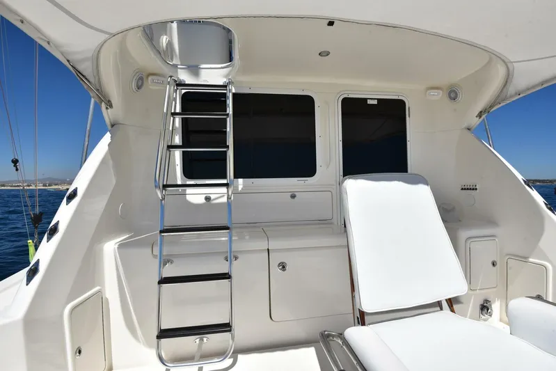 Viviendo El Sueño Yacht Photos Pics 2005 Riviera 51 yacht deck with ladder and white lounge chair.