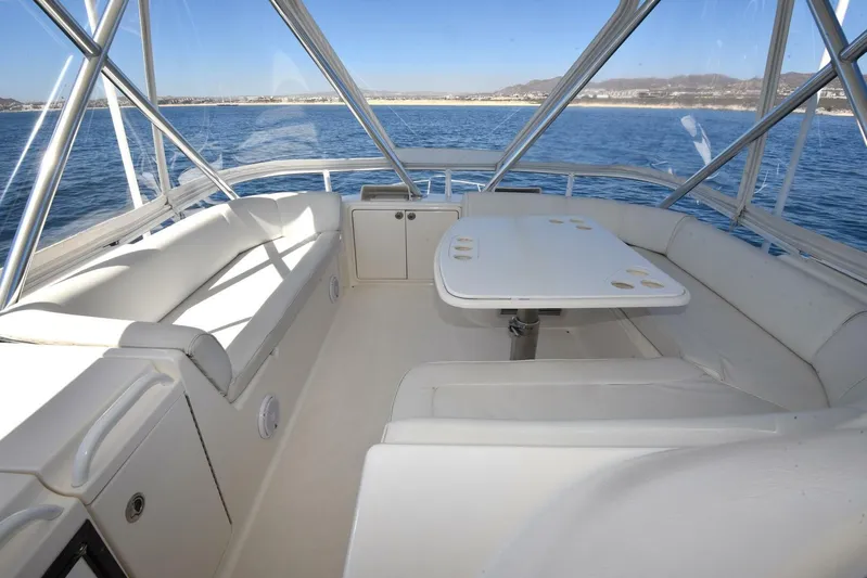 Viviendo El Sueño Yacht Photos Pics 2005 Riviera 51 yacht interior with seating and table, overlooking ocean view.