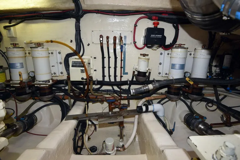Viviendo El Sueño Yacht Photos Pics Engine room of a 2005 Riviera 51 yacht, showcasing fuel filters and piping system.