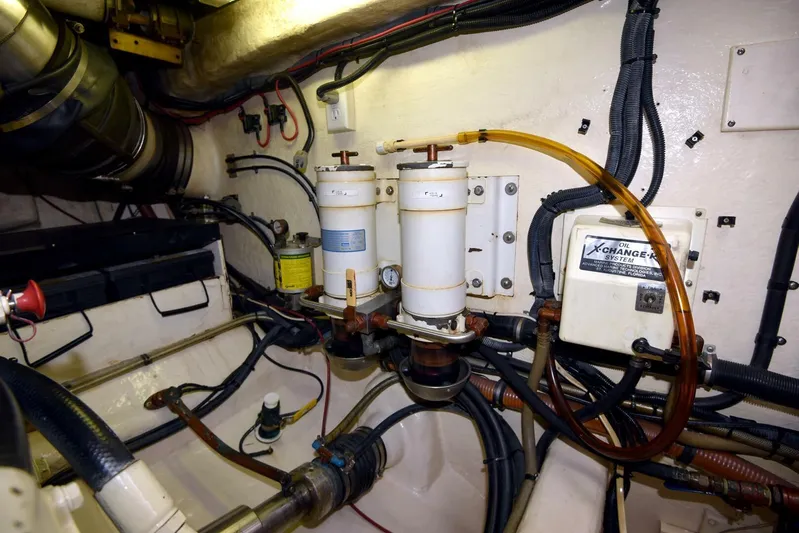 Viviendo El Sueño Yacht Photos Pics Engine room of 2005 Riviera 51 yacht, showcasing fuel filters and wiring.