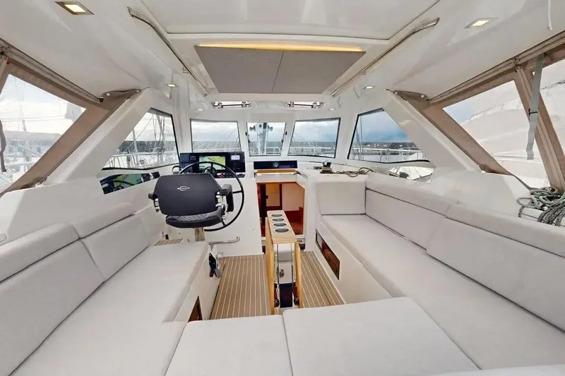 Amel 50 Yacht Photos Pics Luxurious interior of 2023 Amel 50 yacht with modern seating and navigation area.