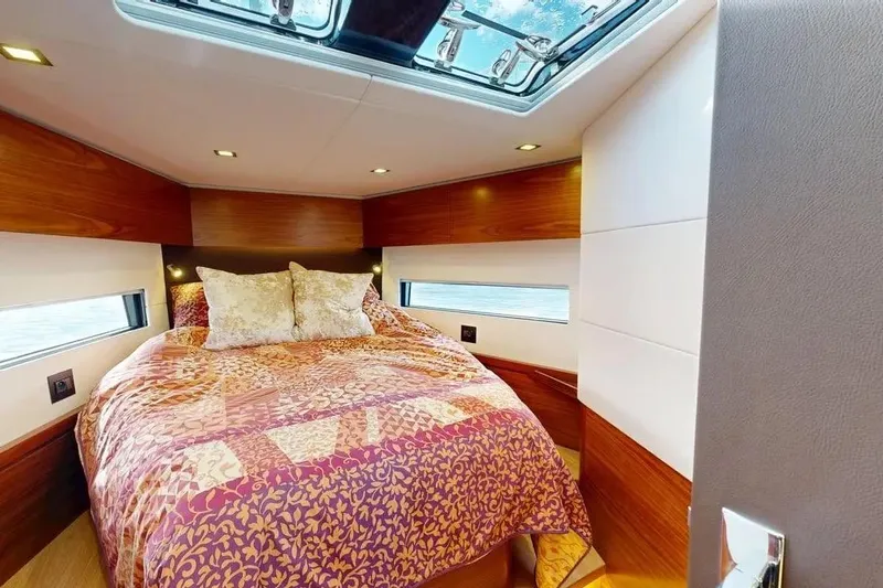 Amel 50 Yacht Photos Pics Luxurious cabin interior of 2023 Amel 50 yacht with cozy bed and skylight.