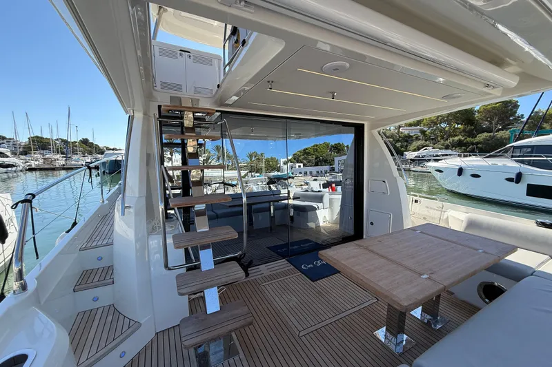  Yacht Photos Pics Luxurious 2024 Prestige 590 yacht interior with modern design and spacious deck area.