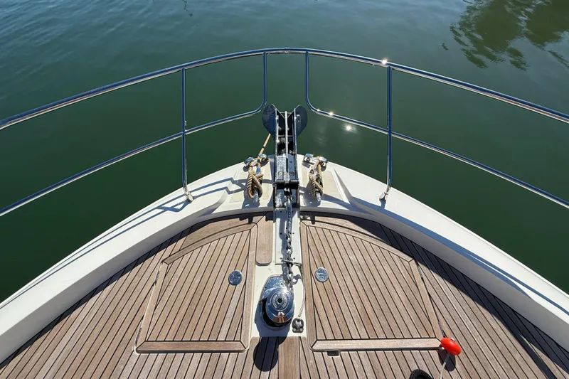  Yacht Photos Pics Bow of 2024 Prestige 590 yacht with wooden deck and anchor system.