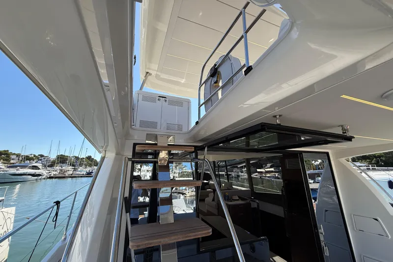  Yacht Photos Pics 2024 Prestige 590 yacht interior with staircase, docked at marina.