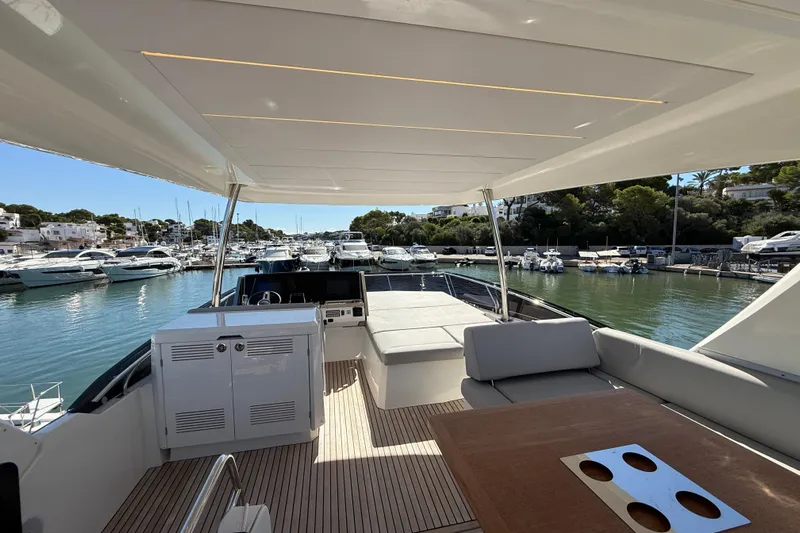  Yacht Photos Pics Luxurious 2024 Prestige 590 yacht interior with spacious seating and marina view.