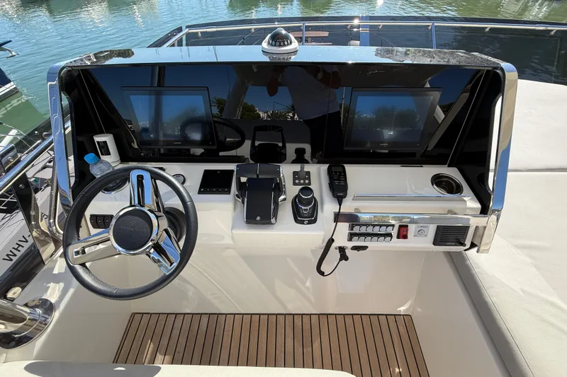  Yacht Photos Pics Helm of 2024 Prestige 590 yacht with modern controls and navigation screens.
