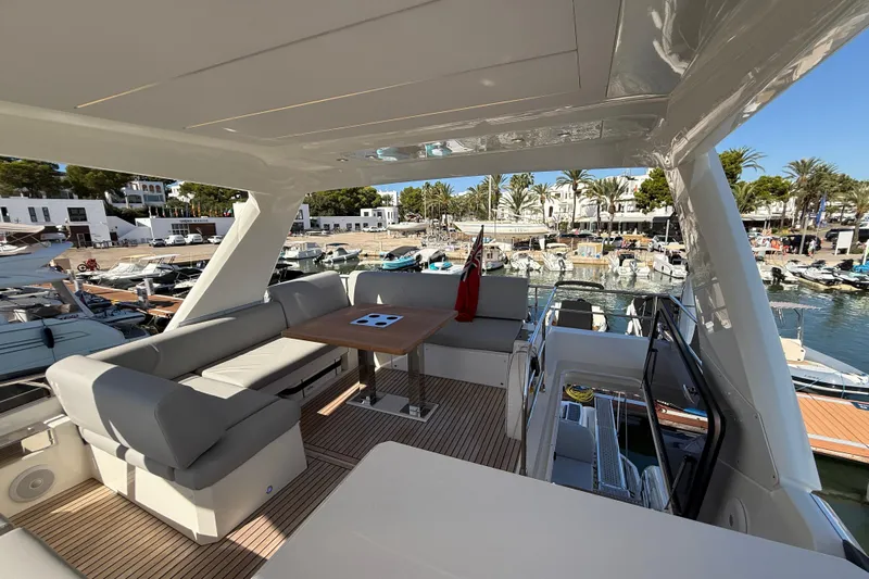  Yacht Photos Pics Luxurious 2024 Prestige 590 yacht interior with elegant seating and marina view.