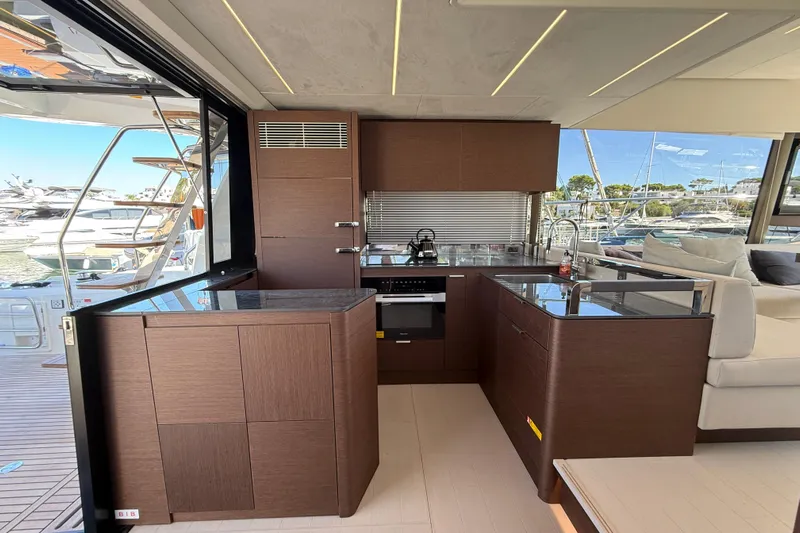  Yacht Photos Pics Luxurious kitchen interior of 2024 Prestige 590 yacht with modern design and marina view.