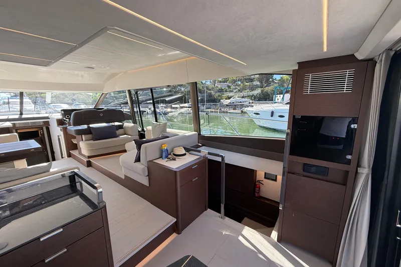  Yacht Photos Pics Luxurious interior of 2024 Prestige 590 yacht with modern furnishings and large windows.