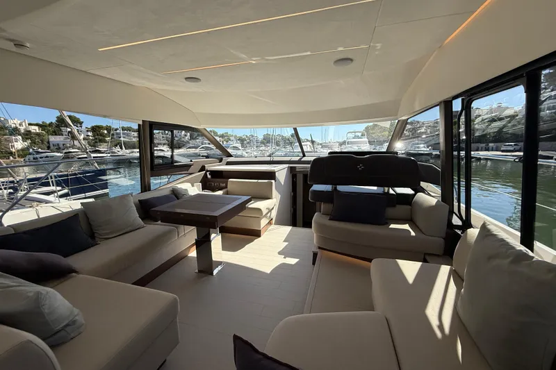  Yacht Photos Pics Luxurious interior of 2024 Prestige 590 yacht with elegant seating and marina view.