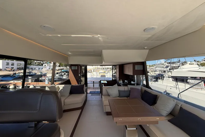  Yacht Photos Pics Luxurious interior of 2024 Prestige 590 yacht with elegant seating and marina view.