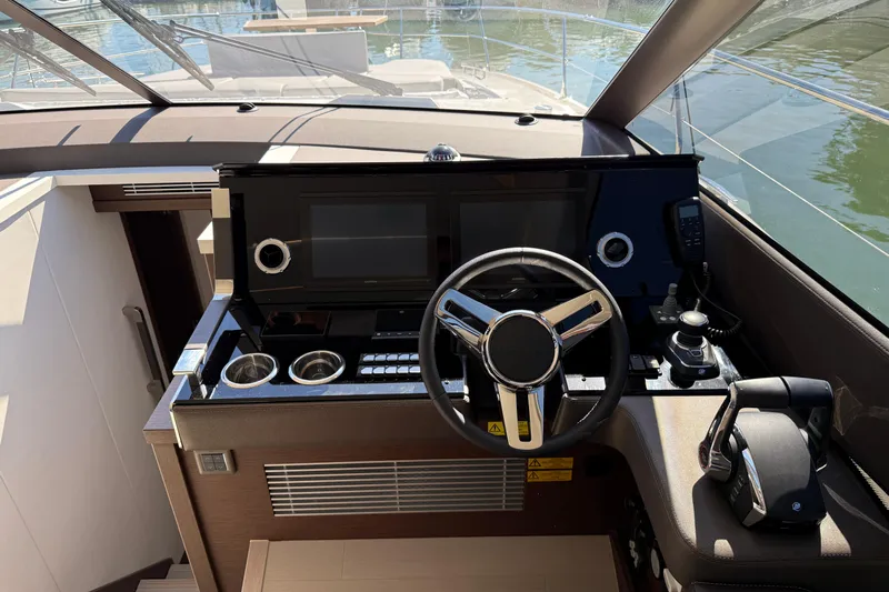  Yacht Photos Pics Modern helm of 2024 Prestige 590 yacht with sleek controls and navigation systems.