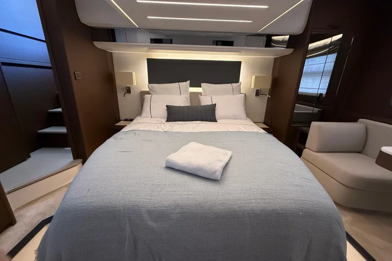  Yacht Photos Pics Luxurious bedroom interior of 2024 Prestige 590 yacht with modern design and cozy bedding.