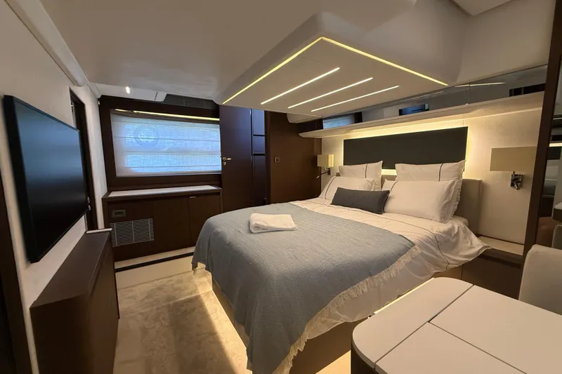  Yacht Photos Pics Luxurious bedroom interior of 2024 Prestige 590 yacht, featuring modern design and ambient lighting.
