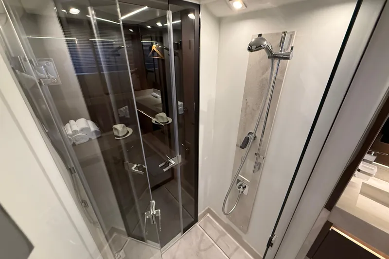  Yacht Photos Pics Luxurious bathroom in 2024 Prestige 590 yacht with modern shower and glass doors.