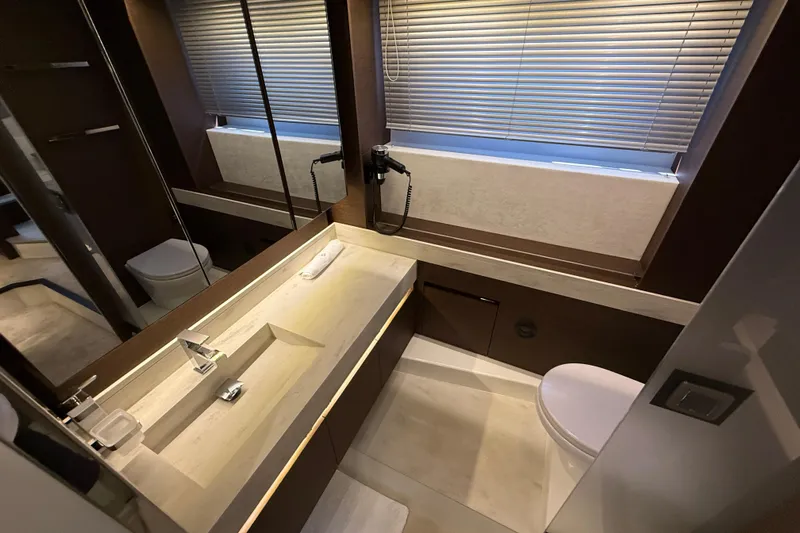  Yacht Photos Pics Luxurious bathroom in 2024 Prestige 590 yacht with modern fixtures and elegant design.