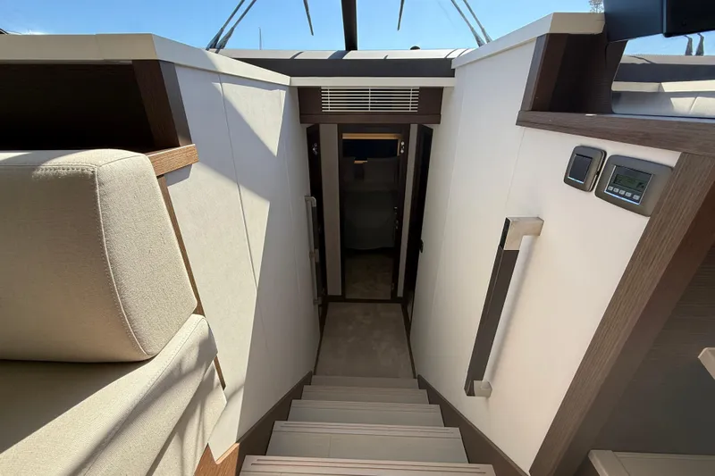  Yacht Photos Pics Interior staircase of 2024 Prestige 590 yacht, featuring modern design and luxurious materials.