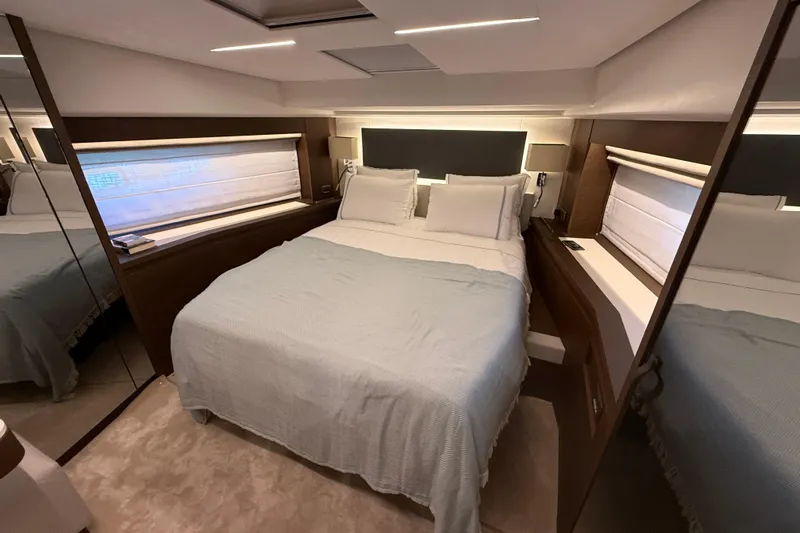  Yacht Photos Pics Luxurious bedroom interior of 2024 Prestige 590 yacht with modern design and cozy bedding.