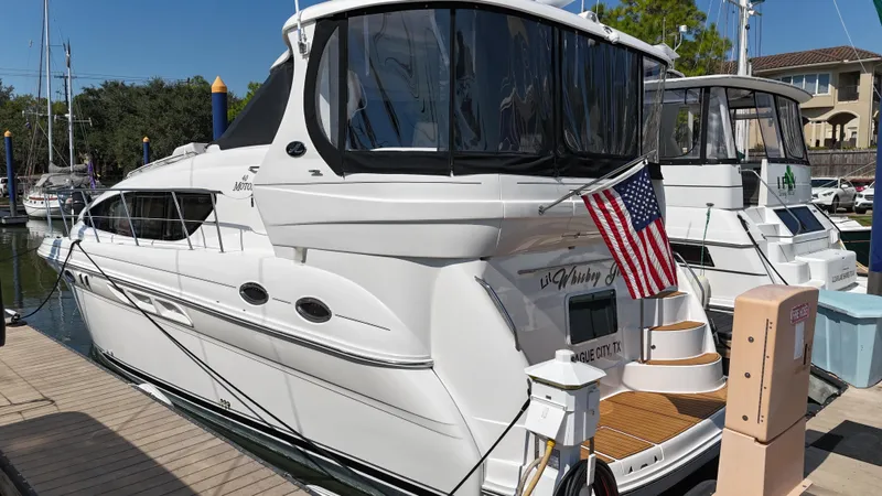 Debs Dinghy Yacht Photos Pics 2007 Sea Ray 40 Motor Yacht docked with American flag, sunny day.