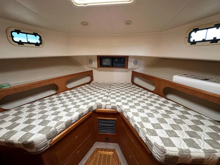  Yacht Photos Pics 2000 Mainship 43 Trawler Aft Cabin interior with checkered bedding and wooden storage.