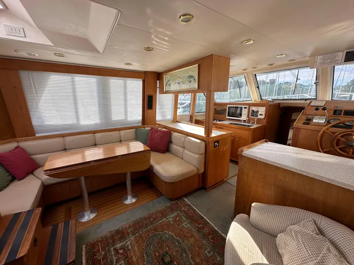  Yacht Photos Pics Interior of 2000 Mainship 43 Trawler Aft Cabin with cozy seating and wooden accents.