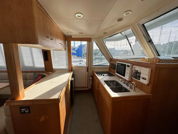 Yacht Photos Pics Interior of 2000 Mainship 43 Trawler Aft Cabin with kitchen and seating area.