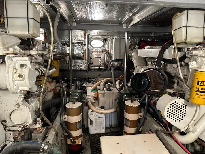  Yacht Photos Pics Engine room of 2000 Mainship 43 Trawler Aft Cabin with visible machinery and components.