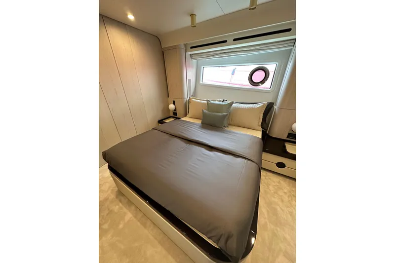  Yacht Photos Pics Luxurious bedroom interior of 2023 Azimut Fly 78 yacht with modern design and large window.