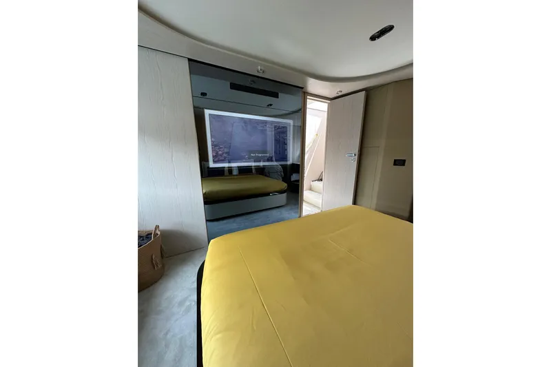  Yacht Photos Pics Luxurious bedroom interior of 2023 Azimut Fly 78 yacht with modern design and yellow bedding.